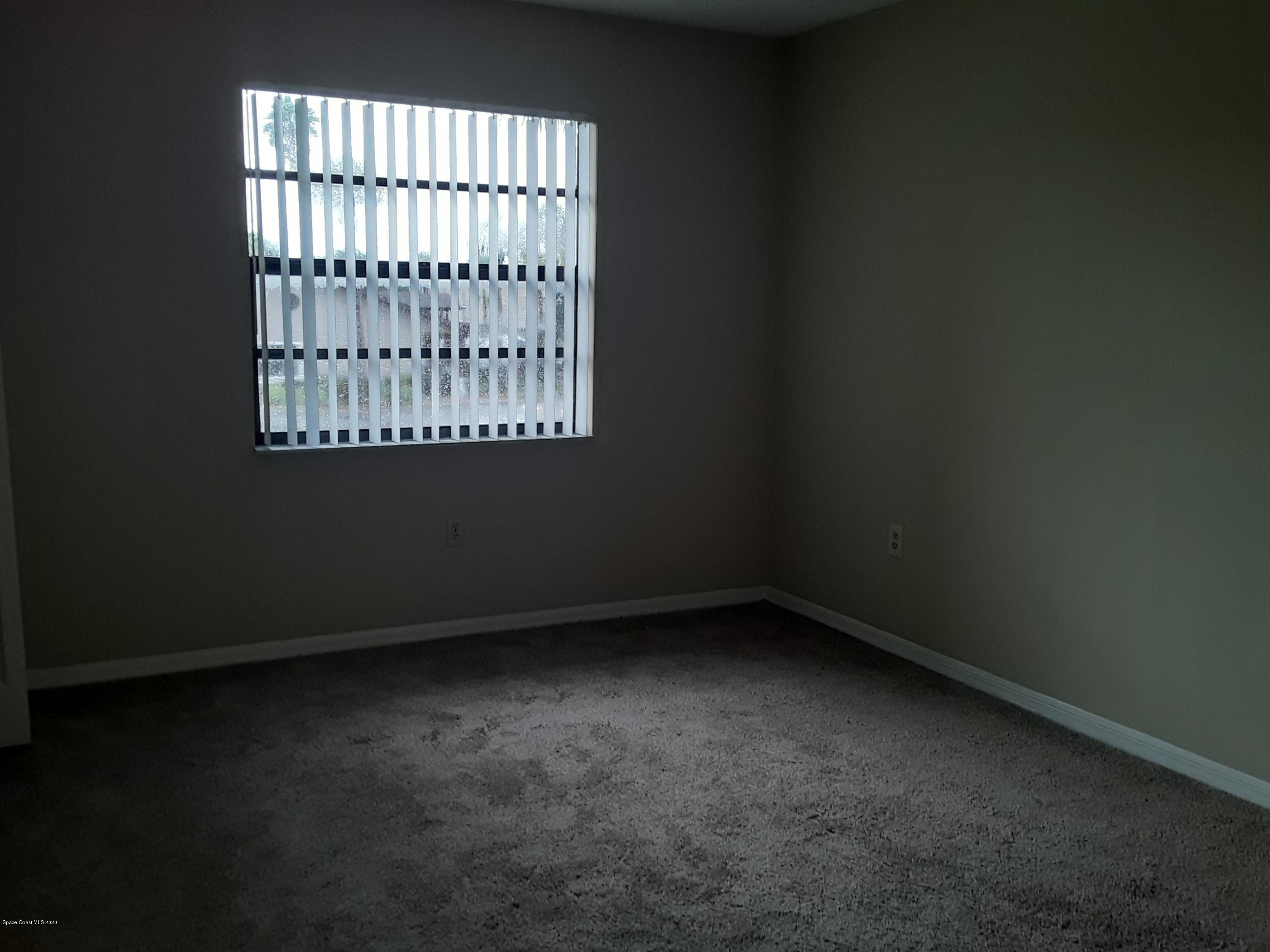 1049 June Drive Melbourne, FL 32935 - Photo 11 of 12 an empty room with a window