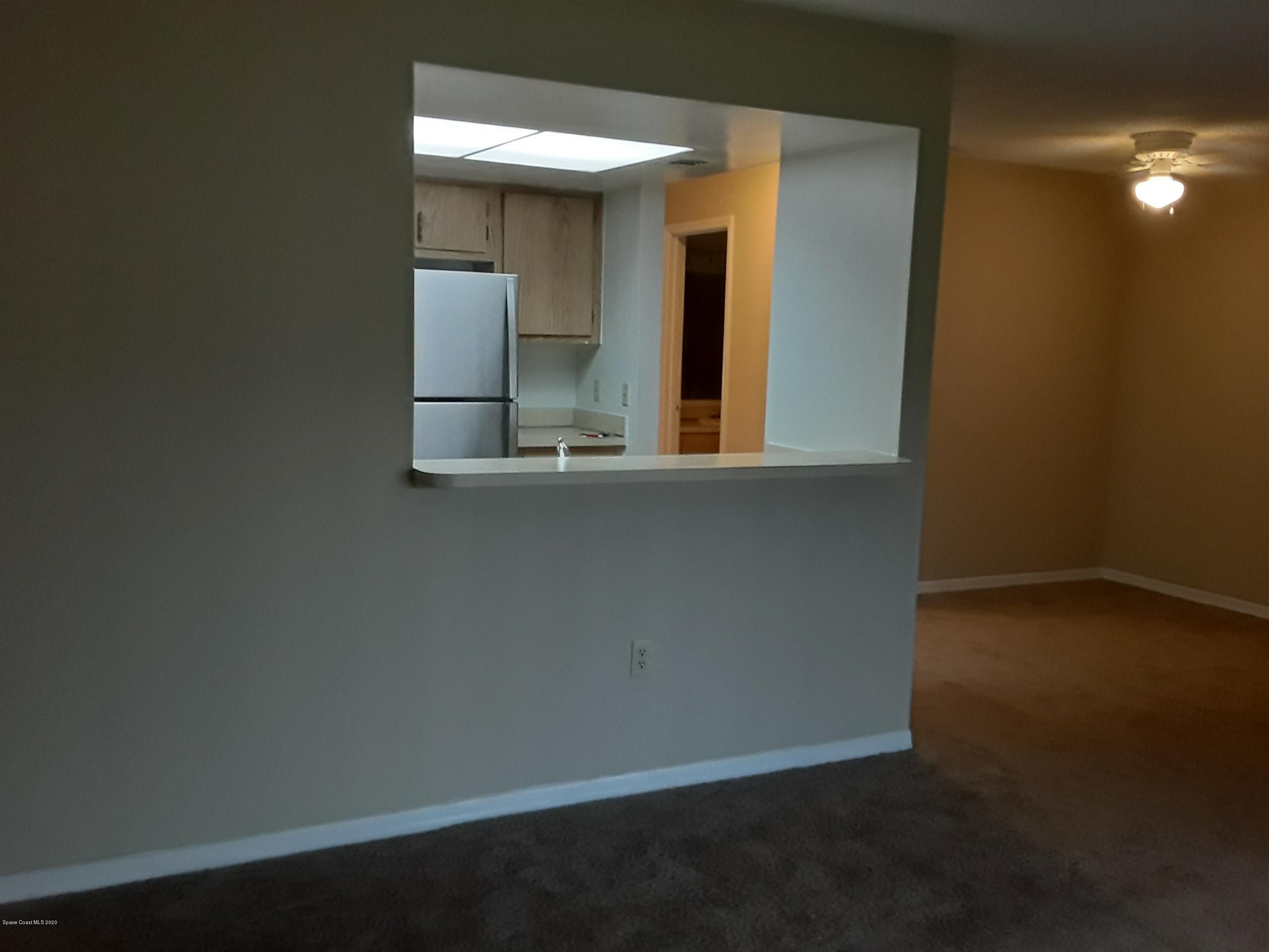 1049 June Drive Melbourne, FL 32935 - Photo 5 of 12 an empty room with mirror