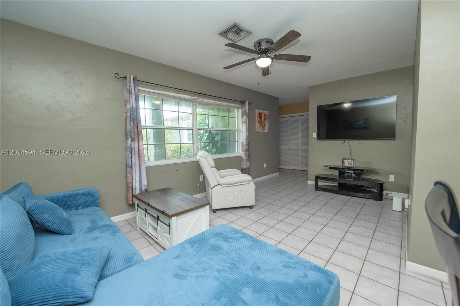 17355 Southwest 256th Street Homestead, FL 33031 - Photo 9 of 32 a living room with furniture and a flat screen tv