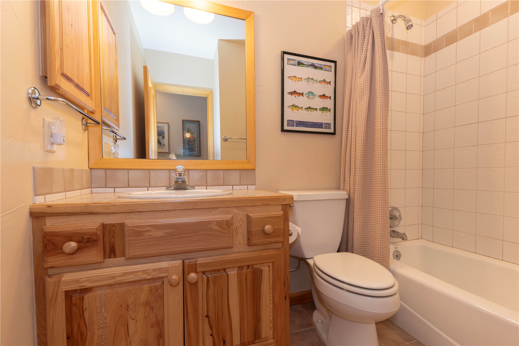760 Penstemon Road Keystone, CO 80435 - Photo 31 of 39 Full bathroom with shower / tub combo with curtain, vanity, tile patterned floors, and toilet