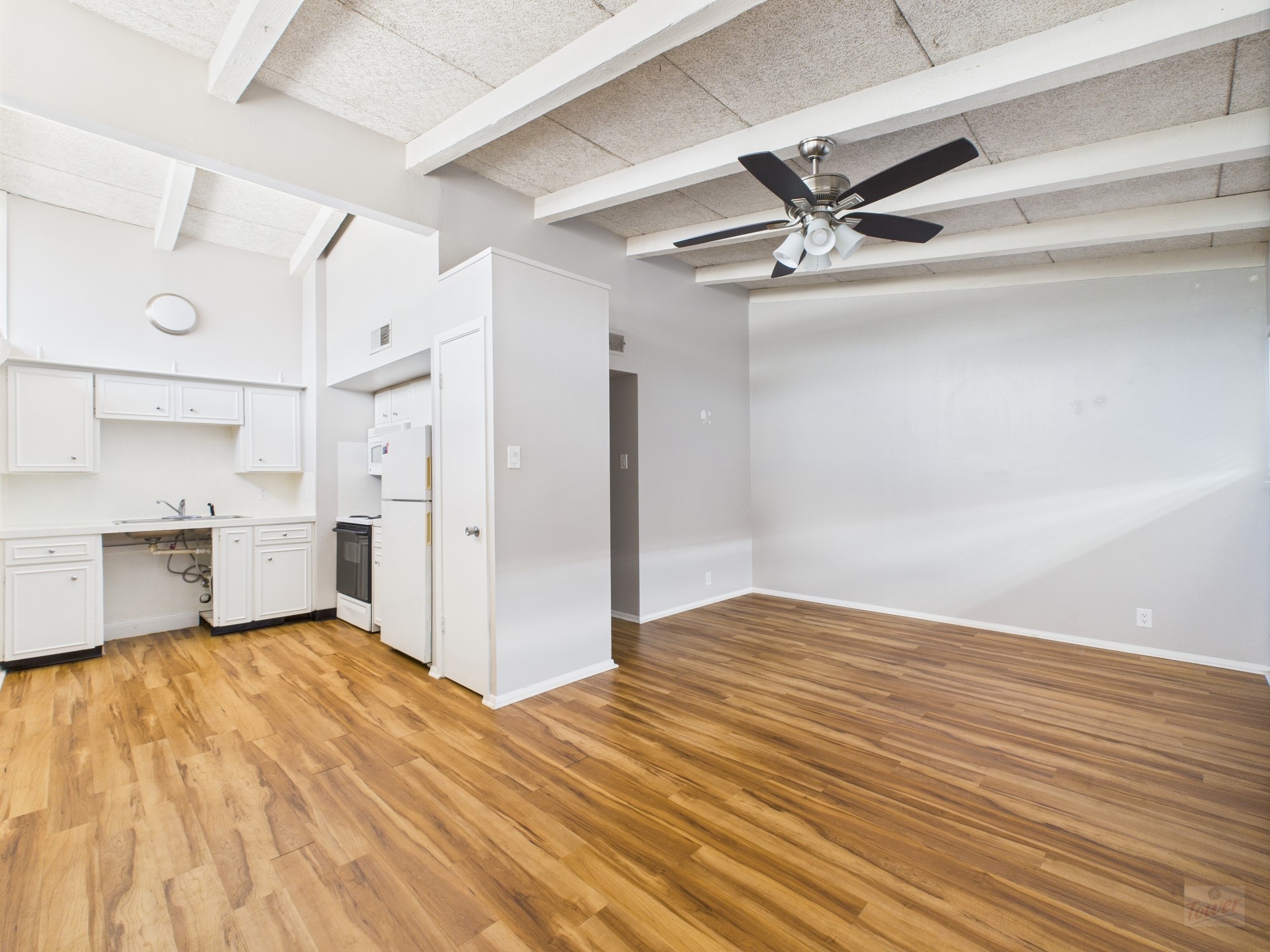 2404 Longview Street, Unit 206 Austin, TX 78705 - Photo 15 of 28 a view of empty room with wooden floor and fan