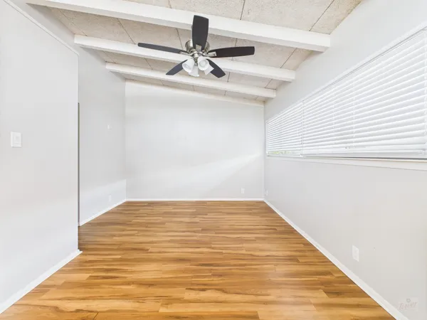 a kitchen with a sink a refrigerator and wooden floor