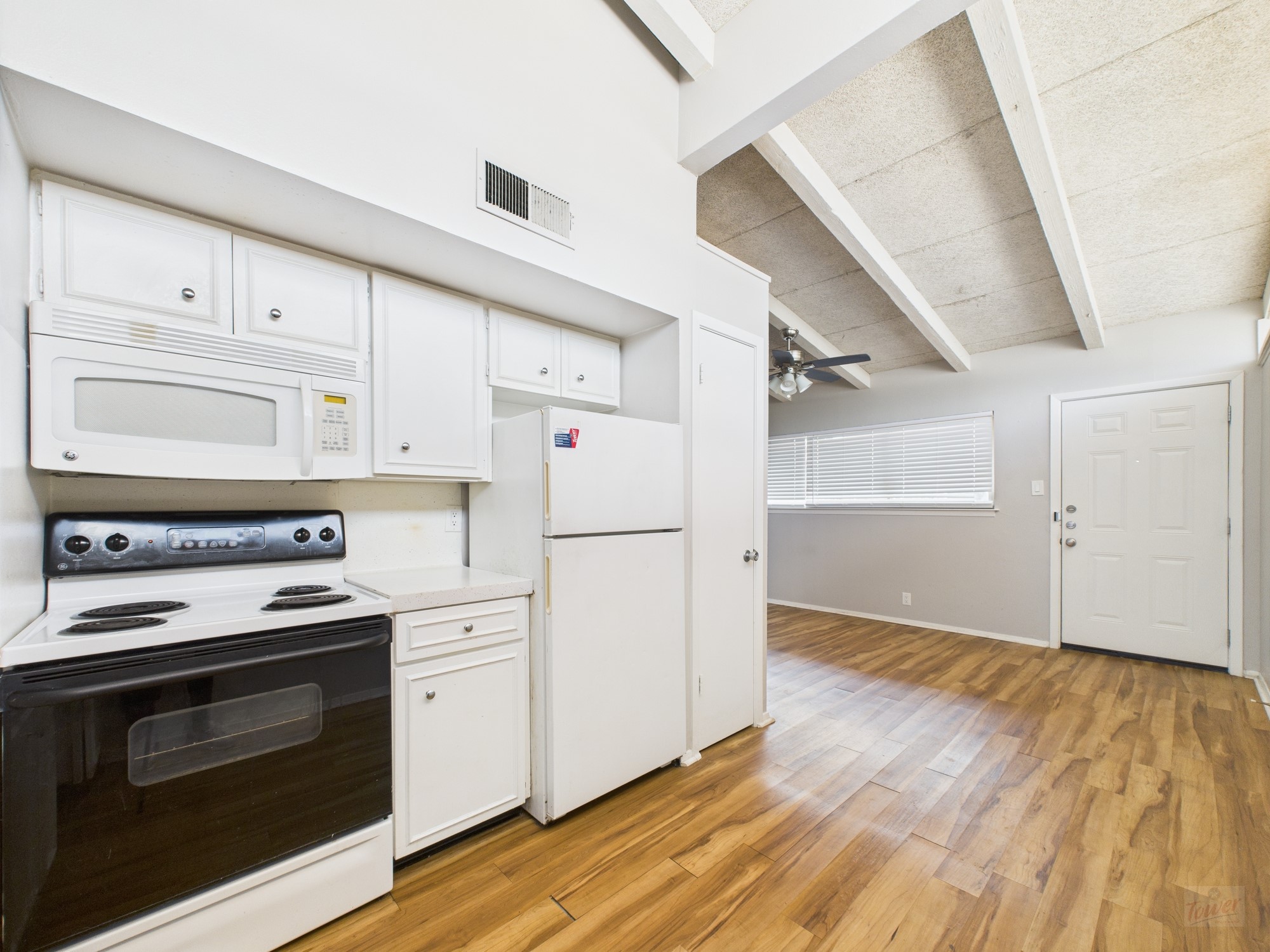 2404 Longview Street, Unit 206 Austin, TX 78705 - Photo 20 of 28 a kitchen with granite countertop white cabinets and white appliances