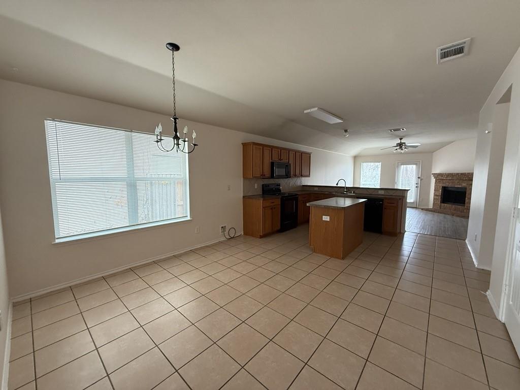 2224 Hummingbird Way Mesquite, TX 75181 - Photo 11 of 28 a kitchen with stainless steel appliances kitchen island granite countertop a refrigerator a stove and a sink
