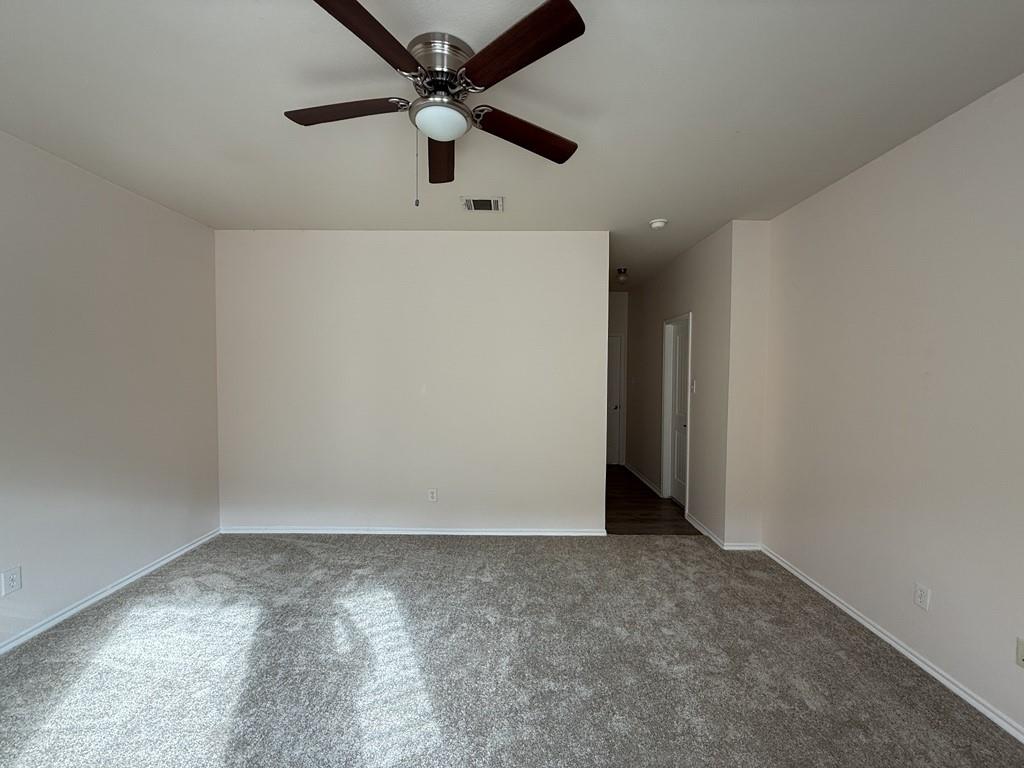 2224 Hummingbird Way Mesquite, TX 75181 - Photo 17 of 28 an empty room with a ceiling fan and window