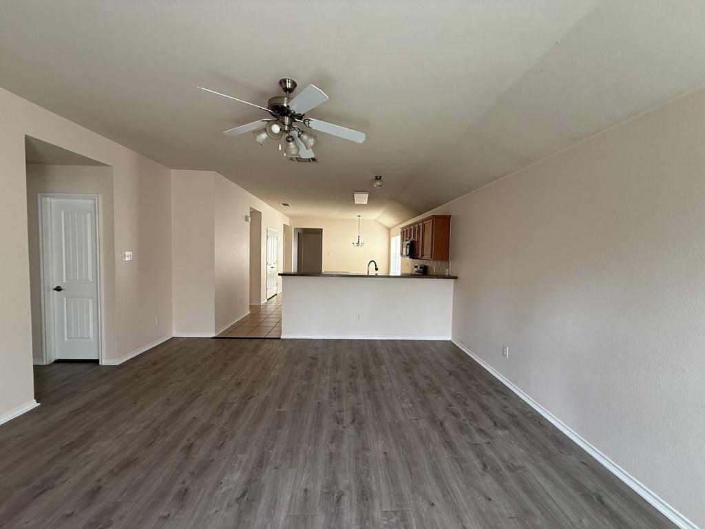 2224 Hummingbird Way Mesquite, TX 75181 - Photo 4 of 28 a view of a kitchen with wooden floor and a ceiling fan