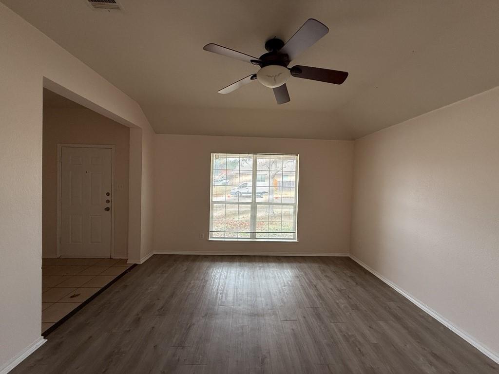 2224 Hummingbird Way Mesquite, TX 75181 - Photo 10 of 28 a view of an empty room with wooden floor and a window