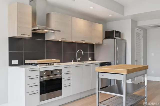 a kitchen with a stove and a refrigerator