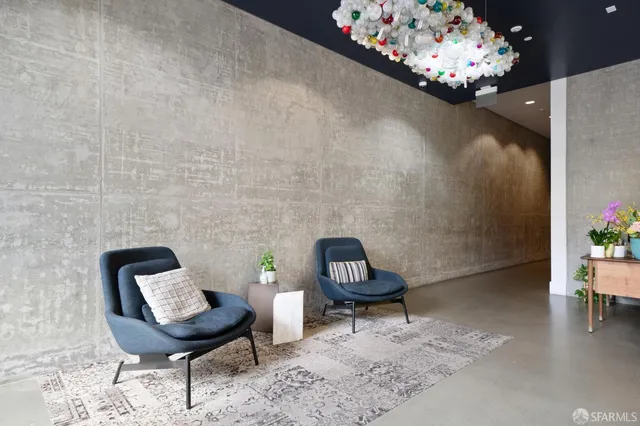 a living room with furniture and a potted plant