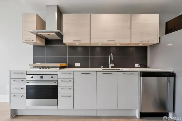 a kitchen with appliances cabinets and a sink