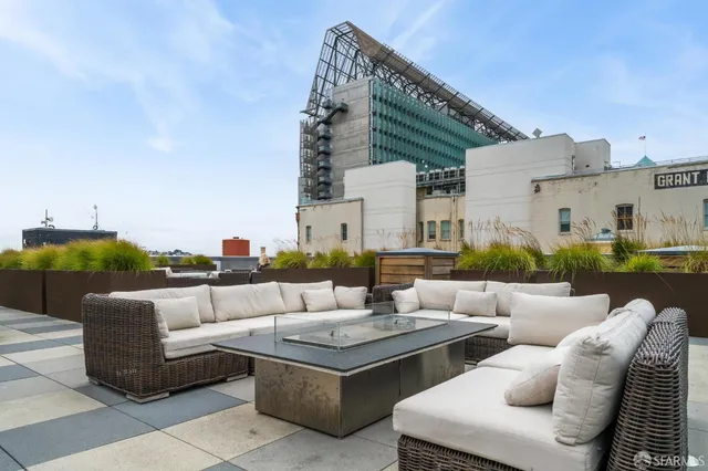 a view of a patio with couches and a fire pit