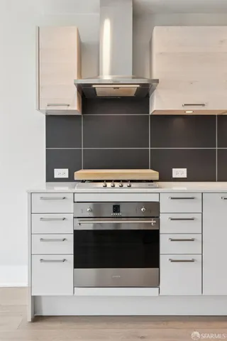 a stove top oven sitting inside of a kitchen