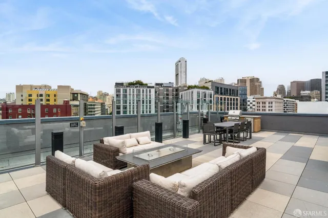 a view of a roof deck with couches and potted plants
