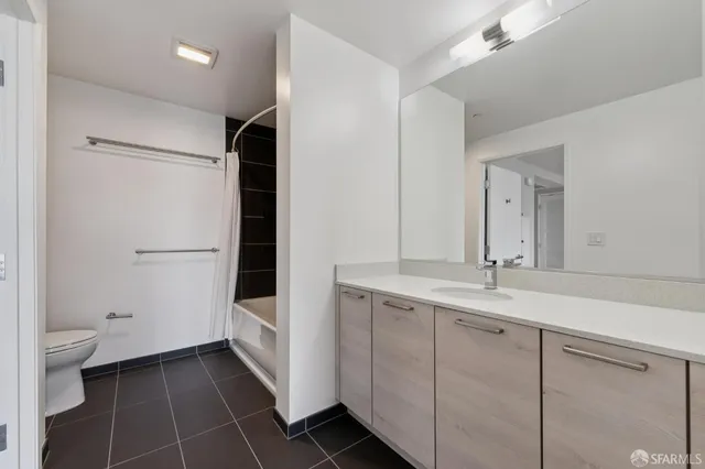 a bathroom with a double vanity sink toilet and shower