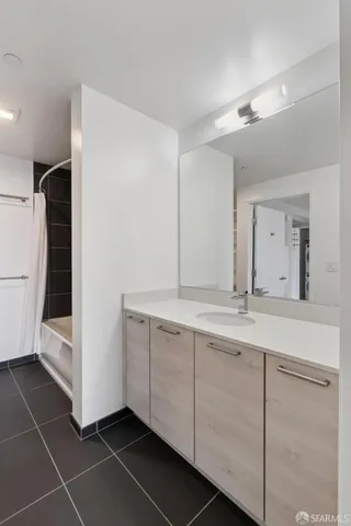 a bathroom with a double vanity sink and mirror