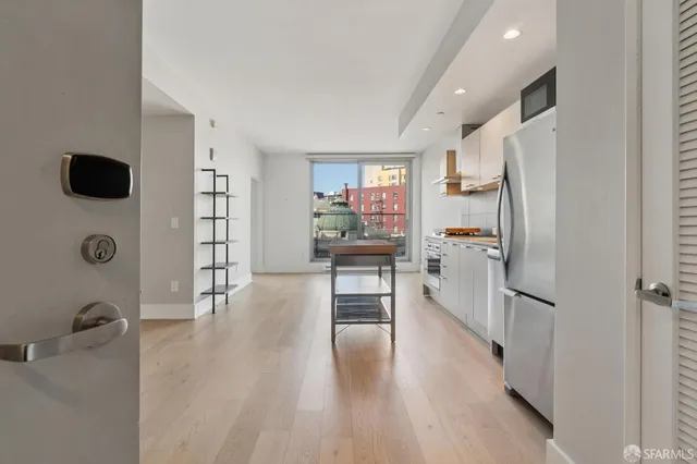 a kitchen with a refrigerator and a stove top oven