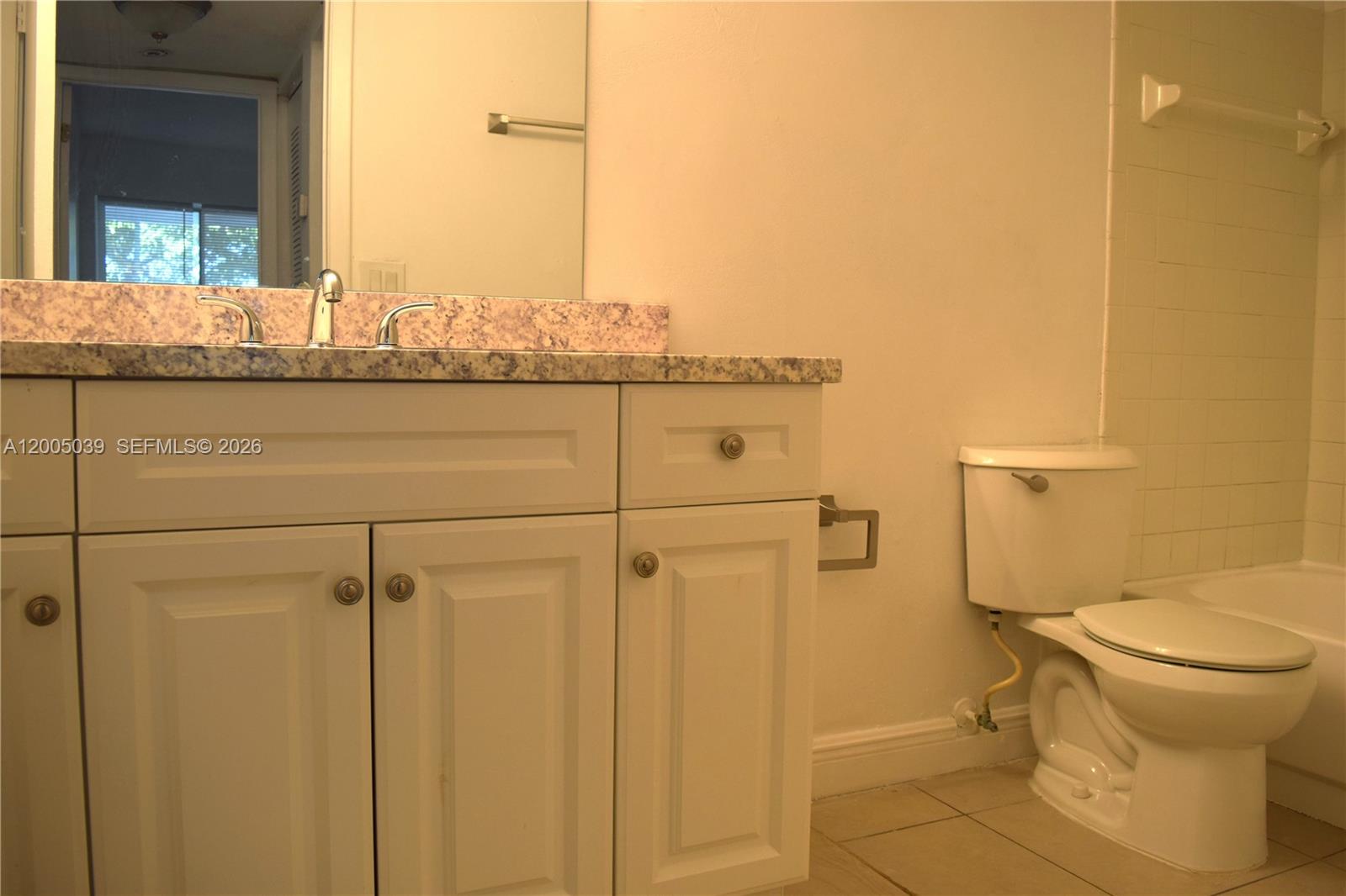 5628 Rock Island Road, Unit 185 Tamarac, FL 33319 - Photo 8 of 29 a bathroom with a granite countertop sink and a toilet