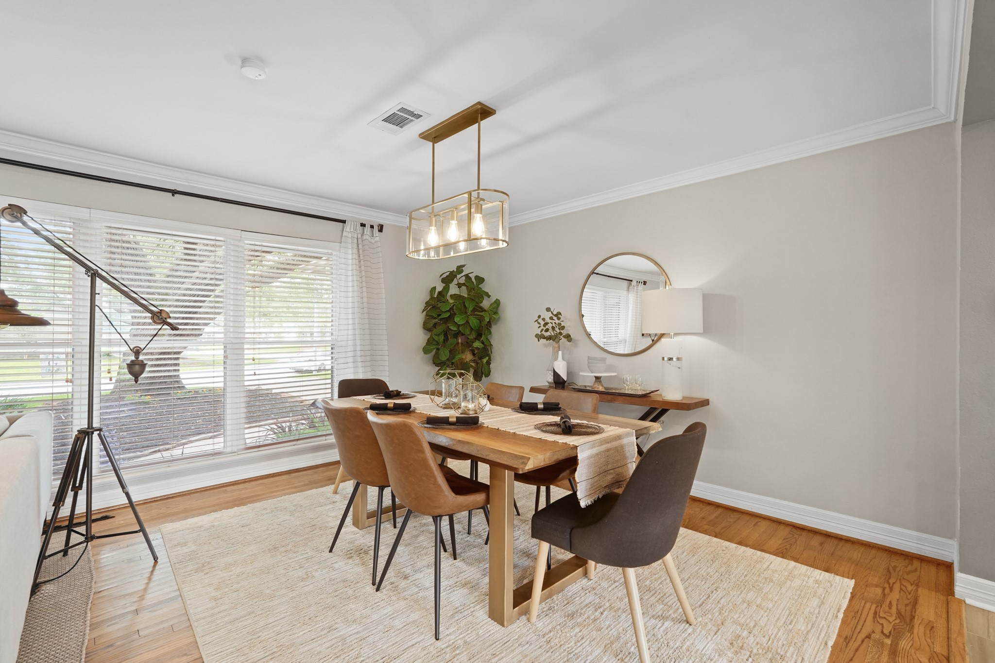 5242 Sanford Road Houston, TX 77035 - Photo 9 of 34 Dining area featuring a large window with natural light, modern chandelier, and enough space for the whole family. Newly painted and the perfect spot to host family and friends.
