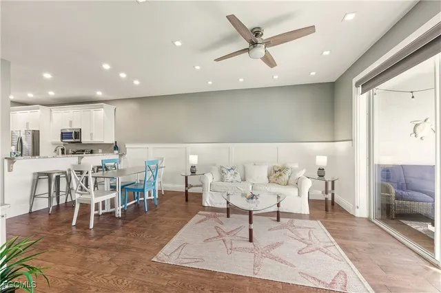 a living room with lots of furniture and kitchen view