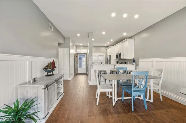 a view of a dining room with furniture and wooden floor