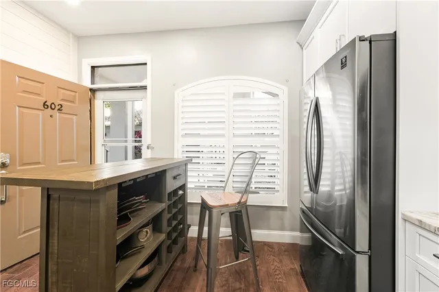 a kitchen with granite countertop a stove and a refrigerator