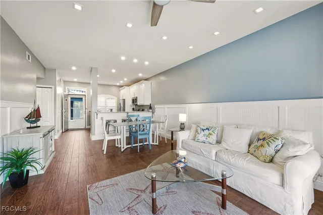 a living room with furniture and a view of kitchen