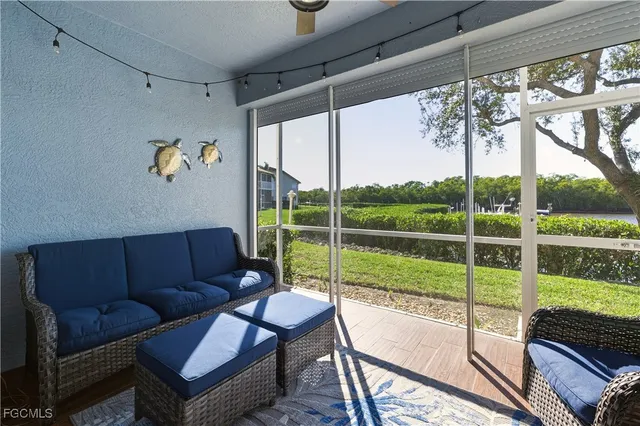 a view of a living room and a porch with furniture