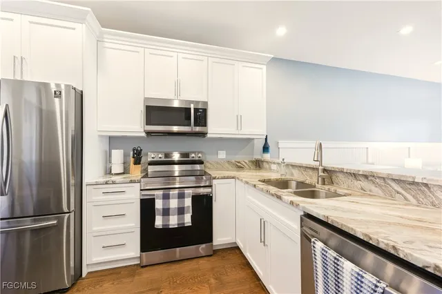 a kitchen with a sink stove and refrigerator