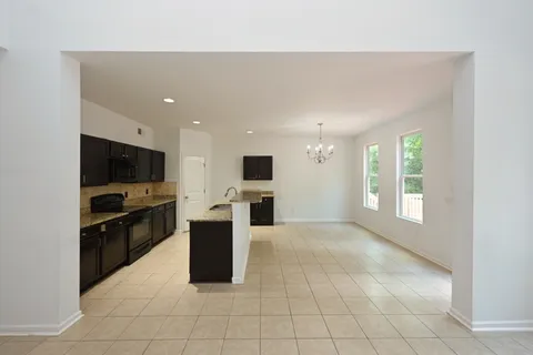a kitchen with stainless steel appliances a stove sink microwave and cabinets