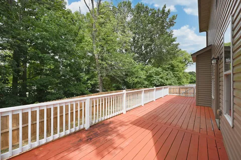 a view of deck with two chairs and wooden floor