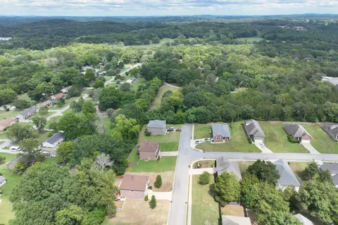 an aerial view of a house with swimming pool and patio
