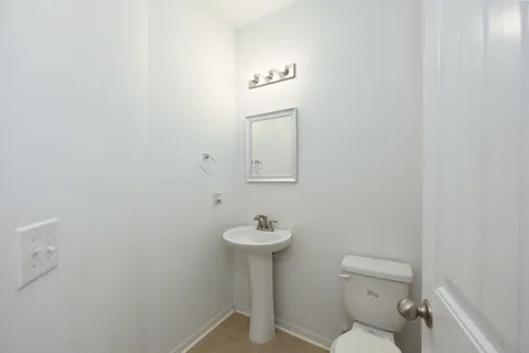 an empty room with windows and fireplace