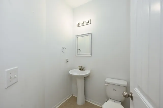 an empty room with windows and fireplace