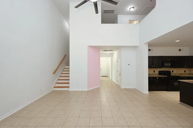 a kitchen with stainless steel appliances kitchen island granite countertop a refrigerator and a stove top oven