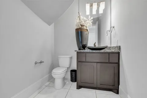 a bathroom with a toilet a sink and a mirror