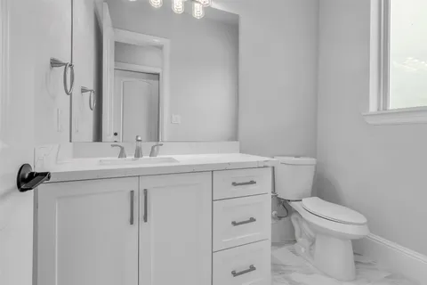 a bathroom with a sink toilet and vanity