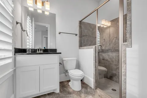 a bathroom with a toilet and a shower