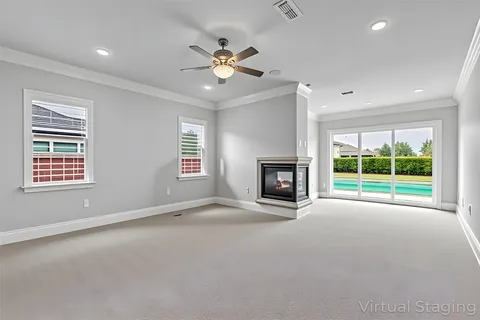 a view of an empty room with a fireplace and a window