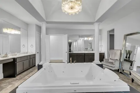 a bathroom with a bathtub and a double vanity sink