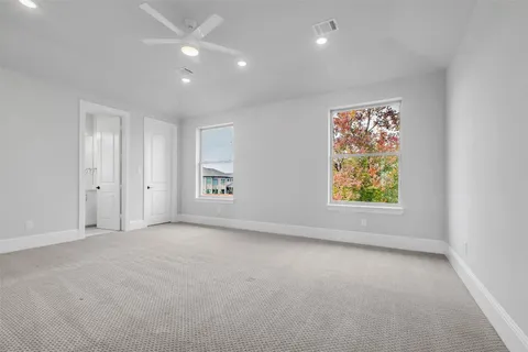an empty room with windows and entrance