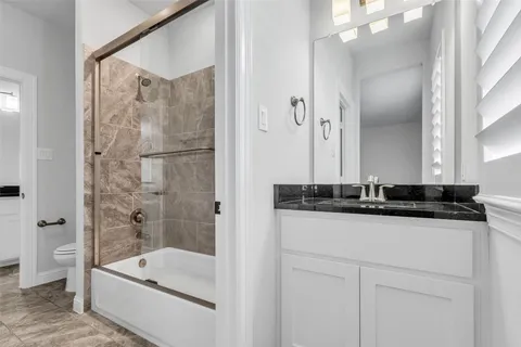 a bathroom with a bathtub a sink and a large mirror