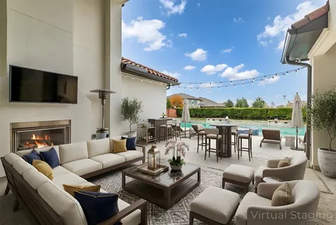 a outdoor living space with patio furniture and a flat screen tv