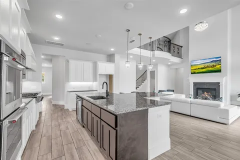 a open kitchen with stainless steel appliances granite countertop a stove and refrigerator