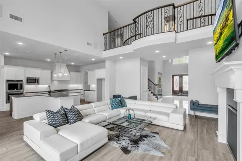 a living room with furniture or kitchen view and a wooden floor