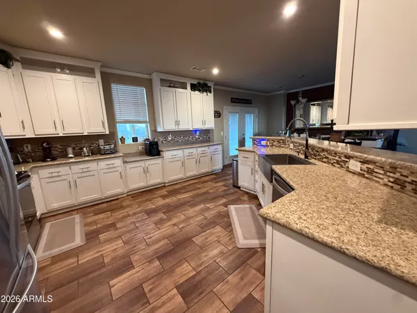 a kitchen with stainless steel appliances granite countertop a sink stove and cabinets