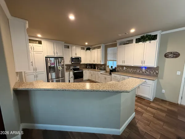 a large kitchen with kitchen island a sink and a stove