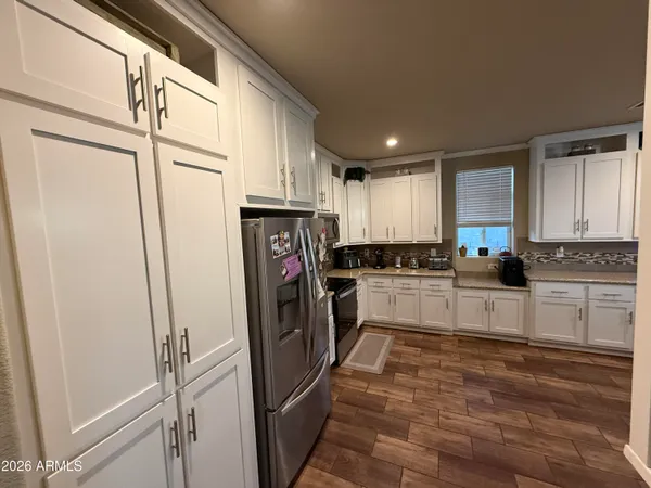 a kitchen with stainless steel appliances granite countertop a refrigerator and a stove top oven
