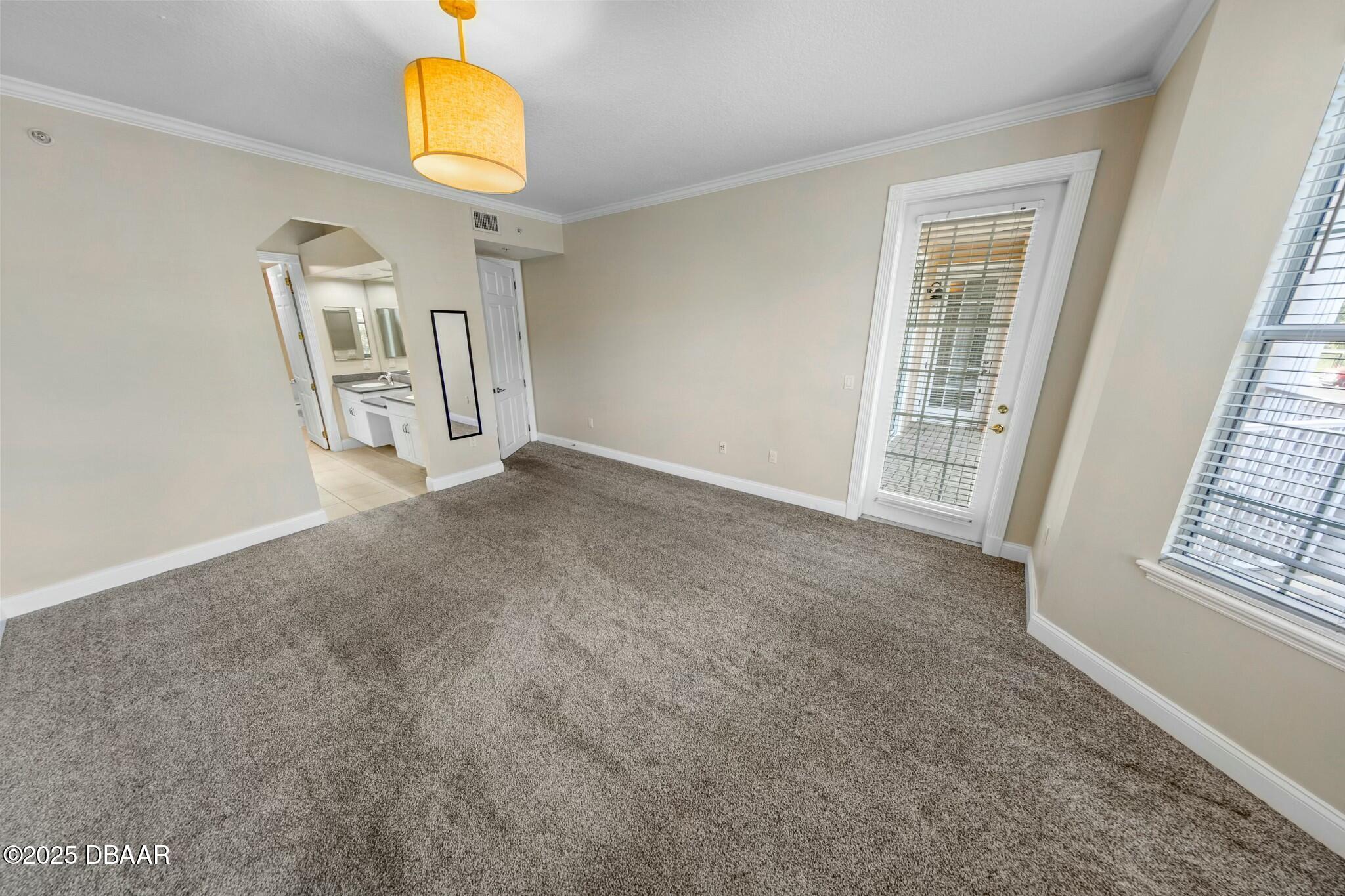4623 Rivers Edge Village Lane, Unit 6204 Ponce Inlet, FL 32127 - Photo 13 of 51 an empty room with windows and entrance