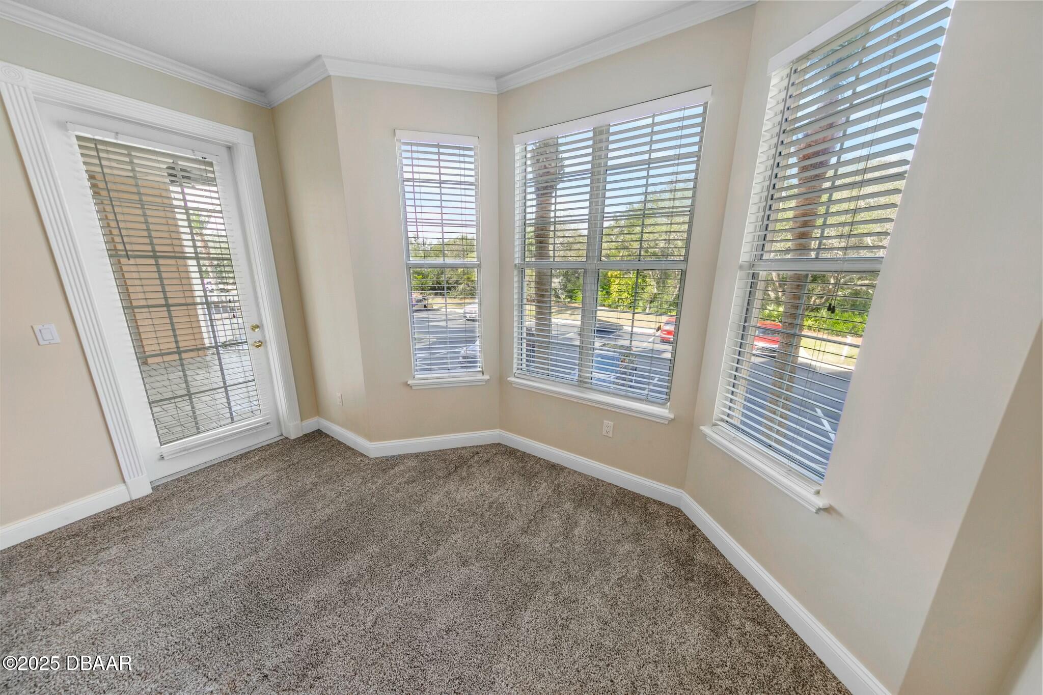 4623 Rivers Edge Village Lane, Unit 6204 Ponce Inlet, FL 32127 - Photo 14 of 51 a view of an empty room with windows