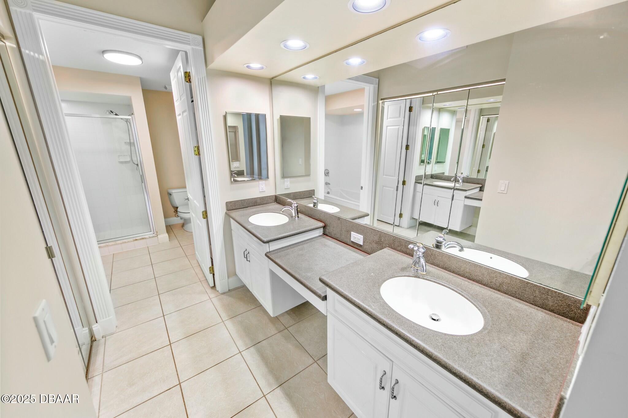 4623 Rivers Edge Village Lane, Unit 6204 Ponce Inlet, FL 32127 - Photo 15 of 51 a spacious bathroom with a granite countertop sink and a mirror